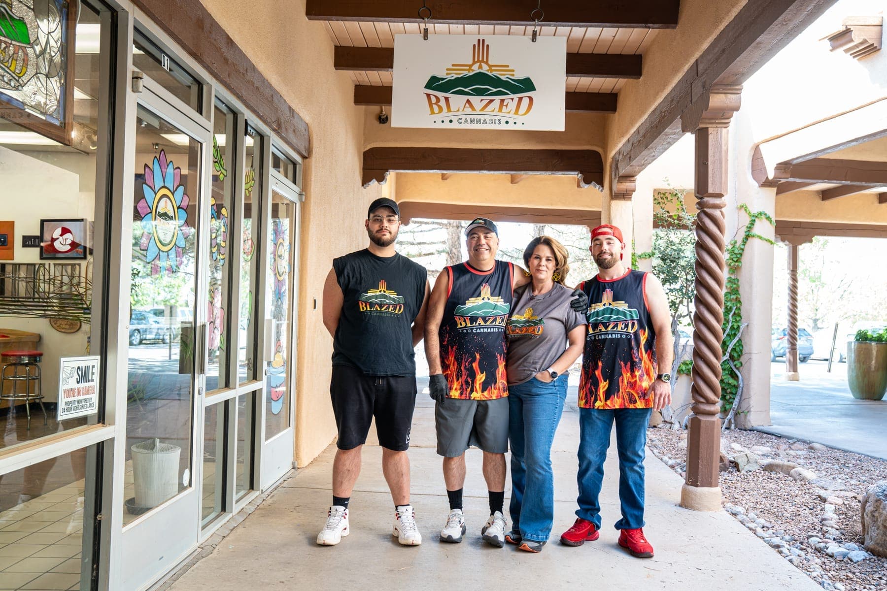 James, Jennifer, Dominic, and Anthony standing together under the portal outside their shop